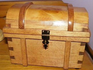 A small wooden treasure chest with a lock on it