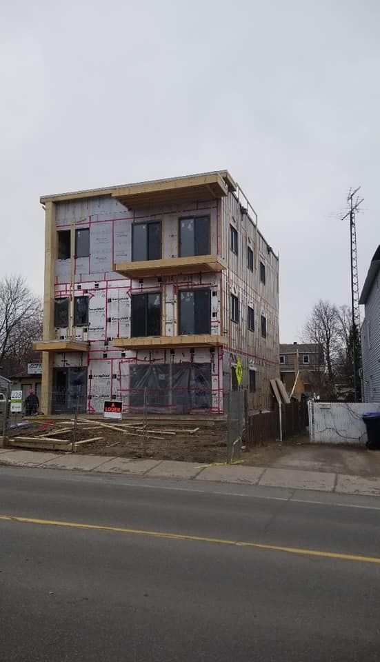 A large building is being built on the side of the road.