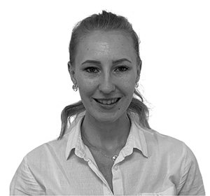 Smiling young woman with blonde hair wearing a white shirt, looking at the camera.