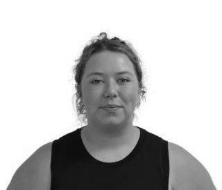 Woman with light skin, black tank top, neutral expression, curly hair, white background.