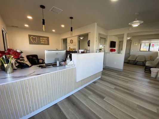 A reception desk in a dental office with a computer on it.