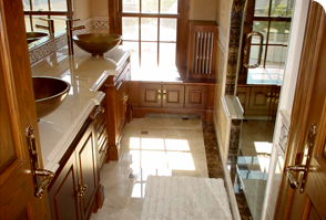 Finished bathroom with granite counter and marble floor