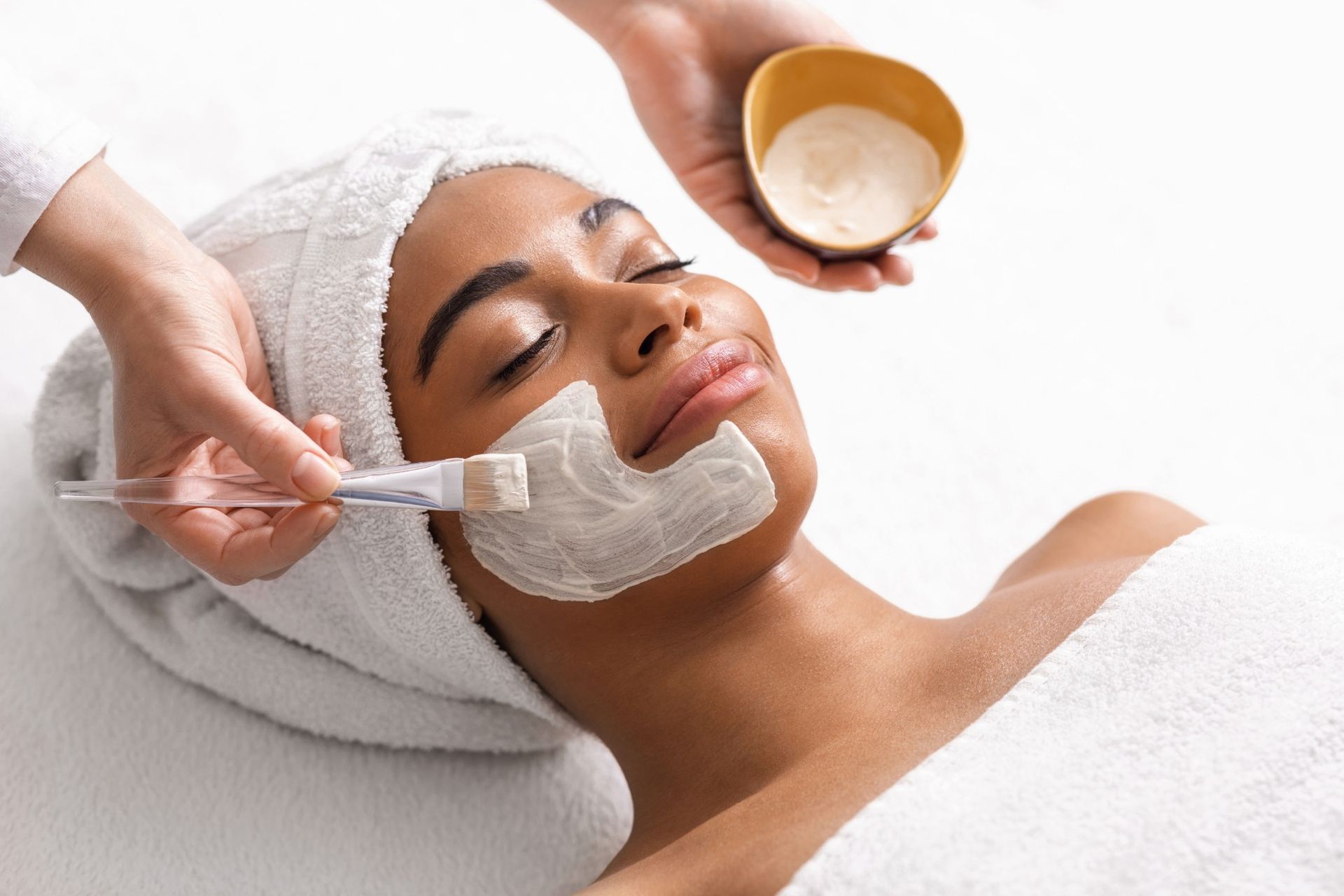 A woman is getting a facial treatment at a spa.