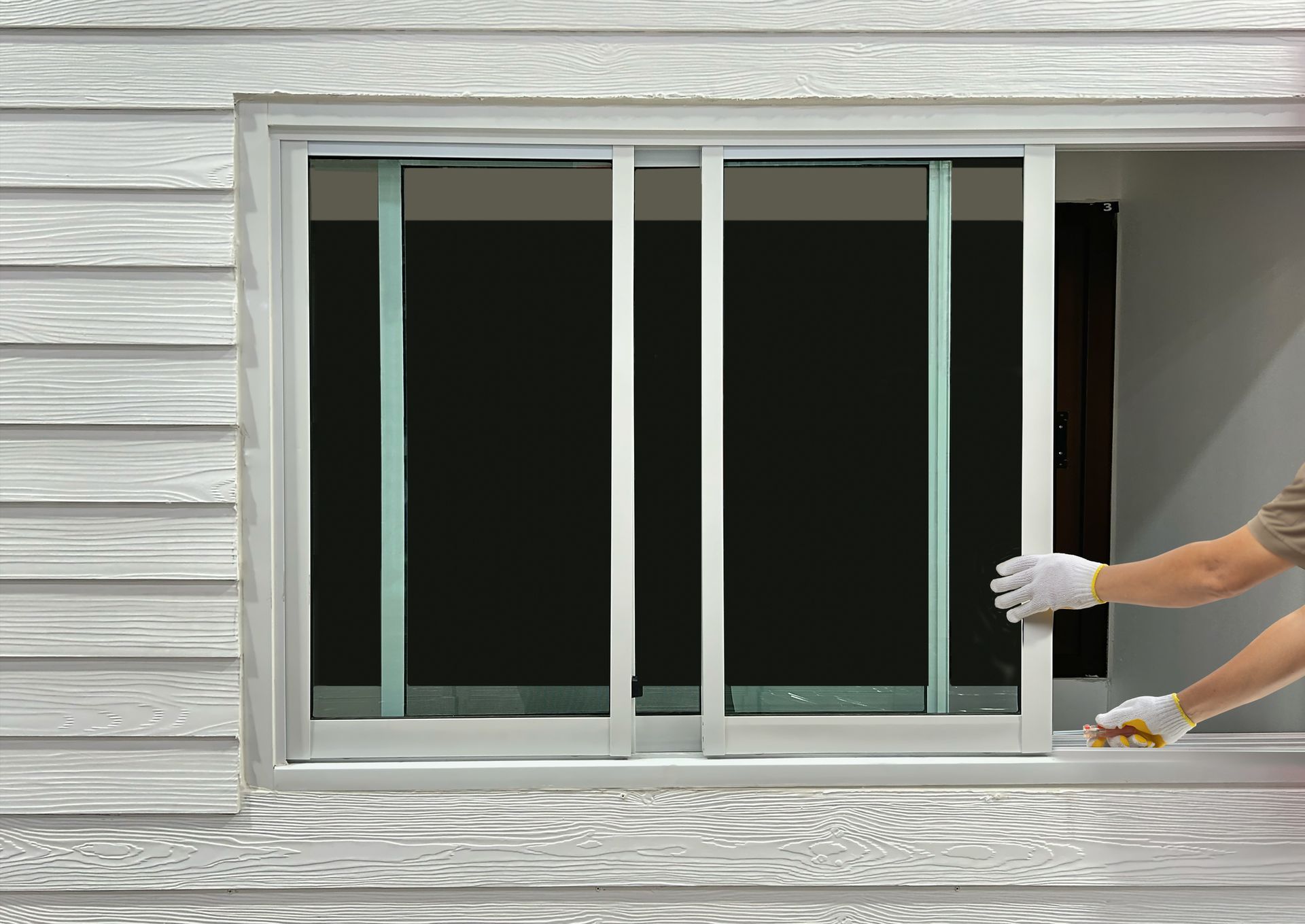 Construction worker repairing the sliding window.
