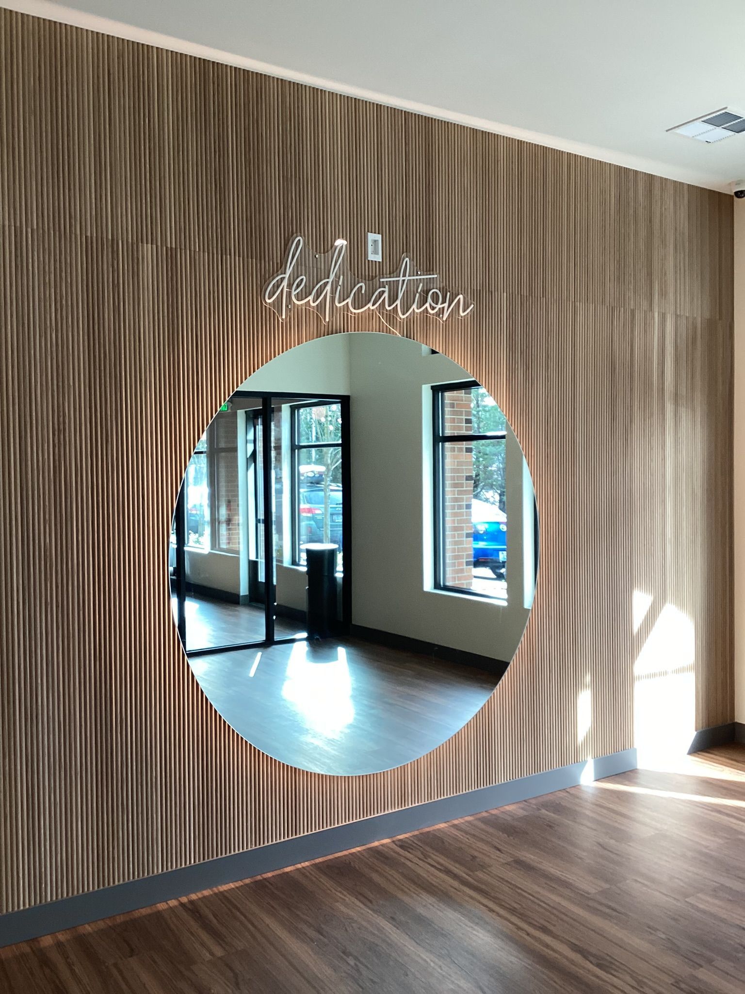 Wooden textured wall with circular mirror, 