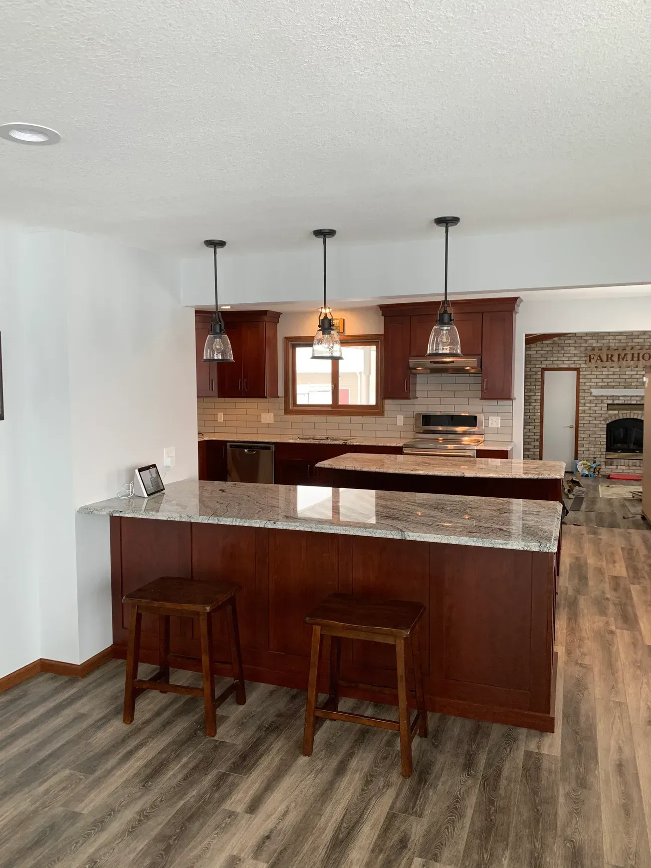 A kitchen with a large island and stools