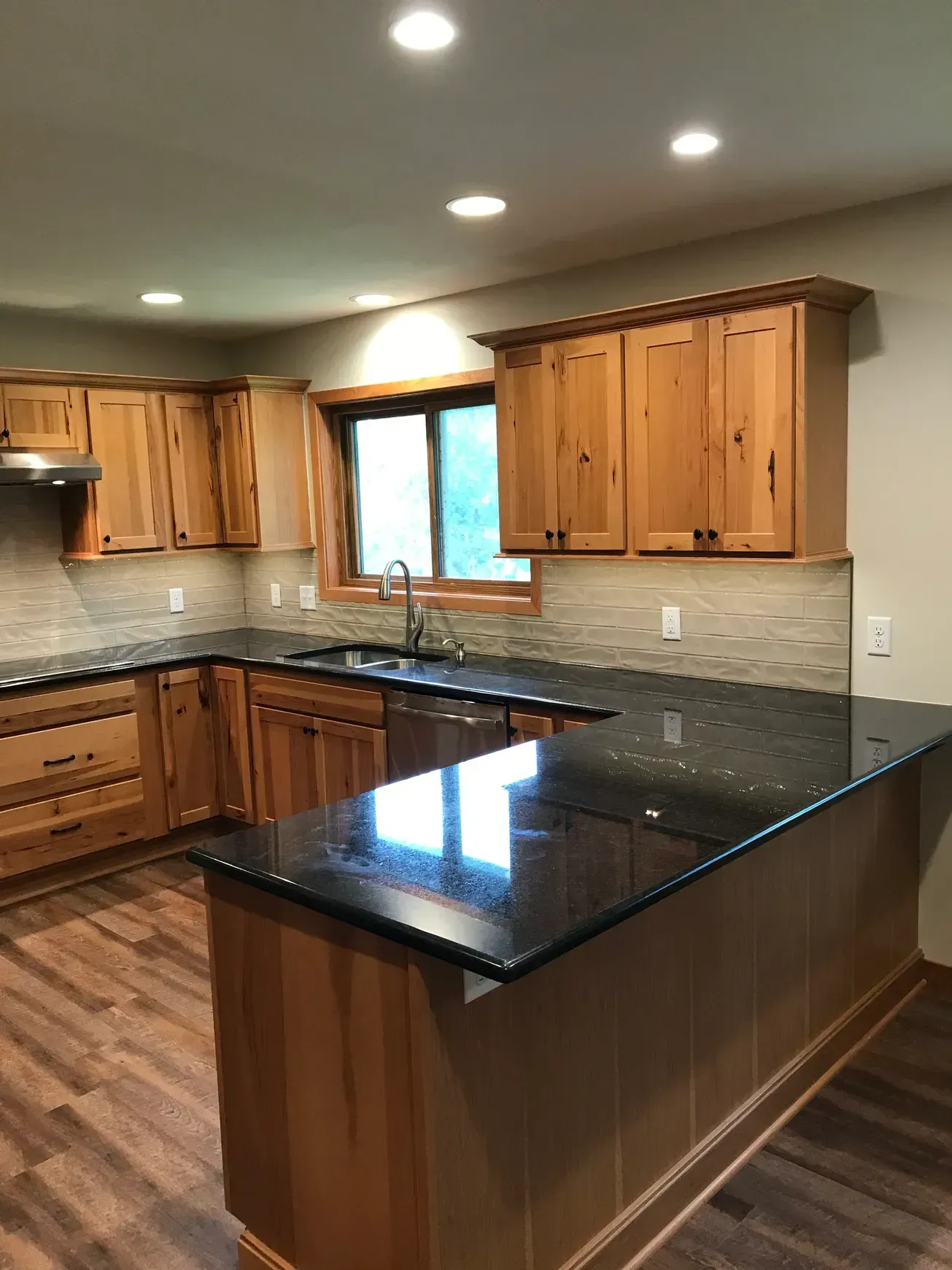 A kitchen with wooden cabinets and granite counter tops.