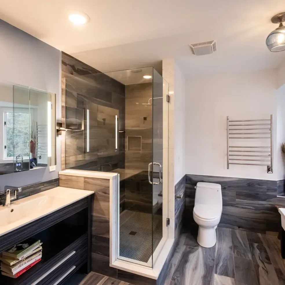 A bathroom with a toilet a sink and a shower