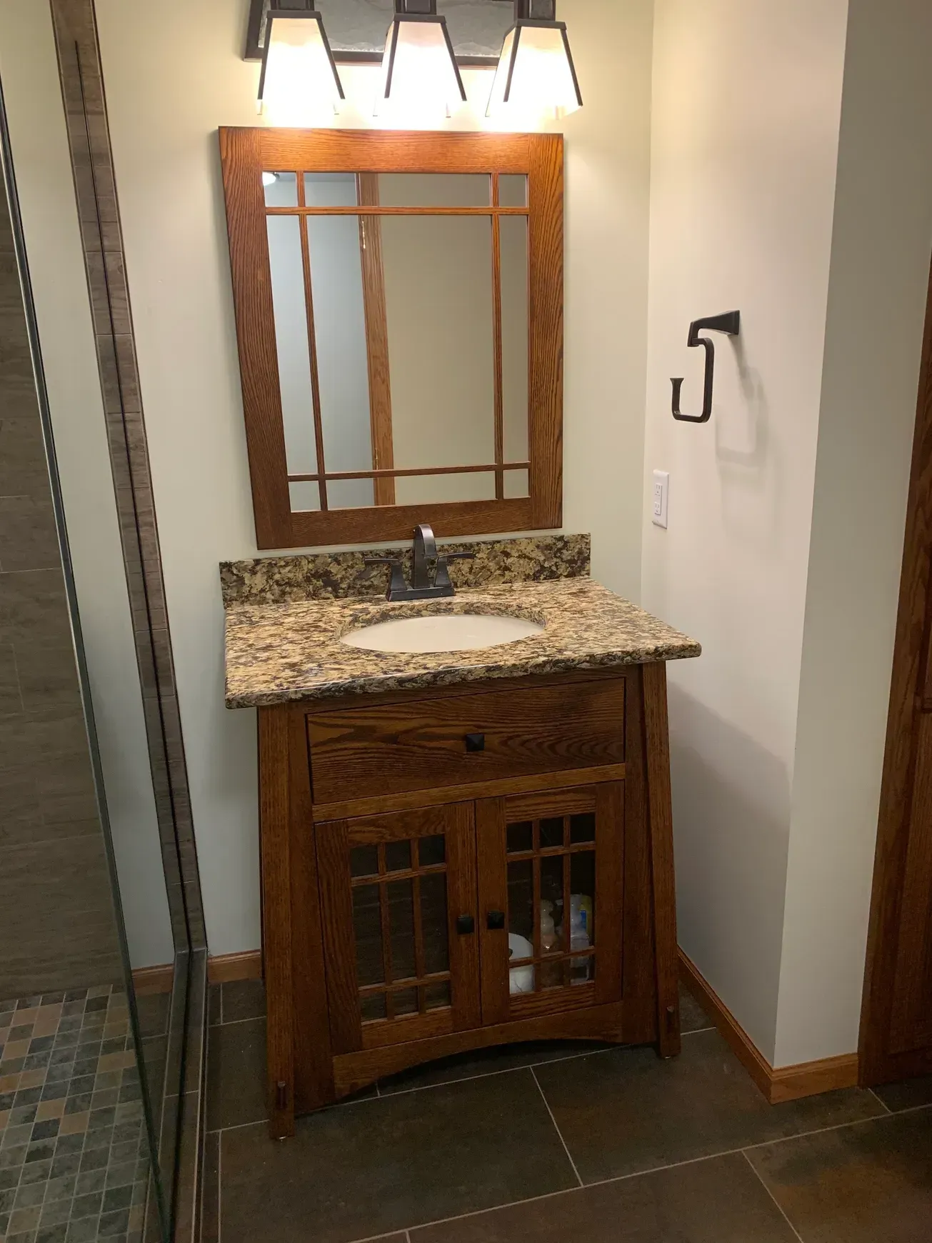 A bathroom vanity with a sink and a mirror.