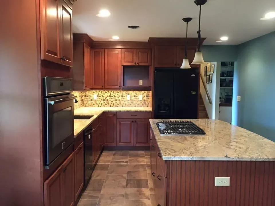 A kitchen with wooden cabinets and granite counter tops