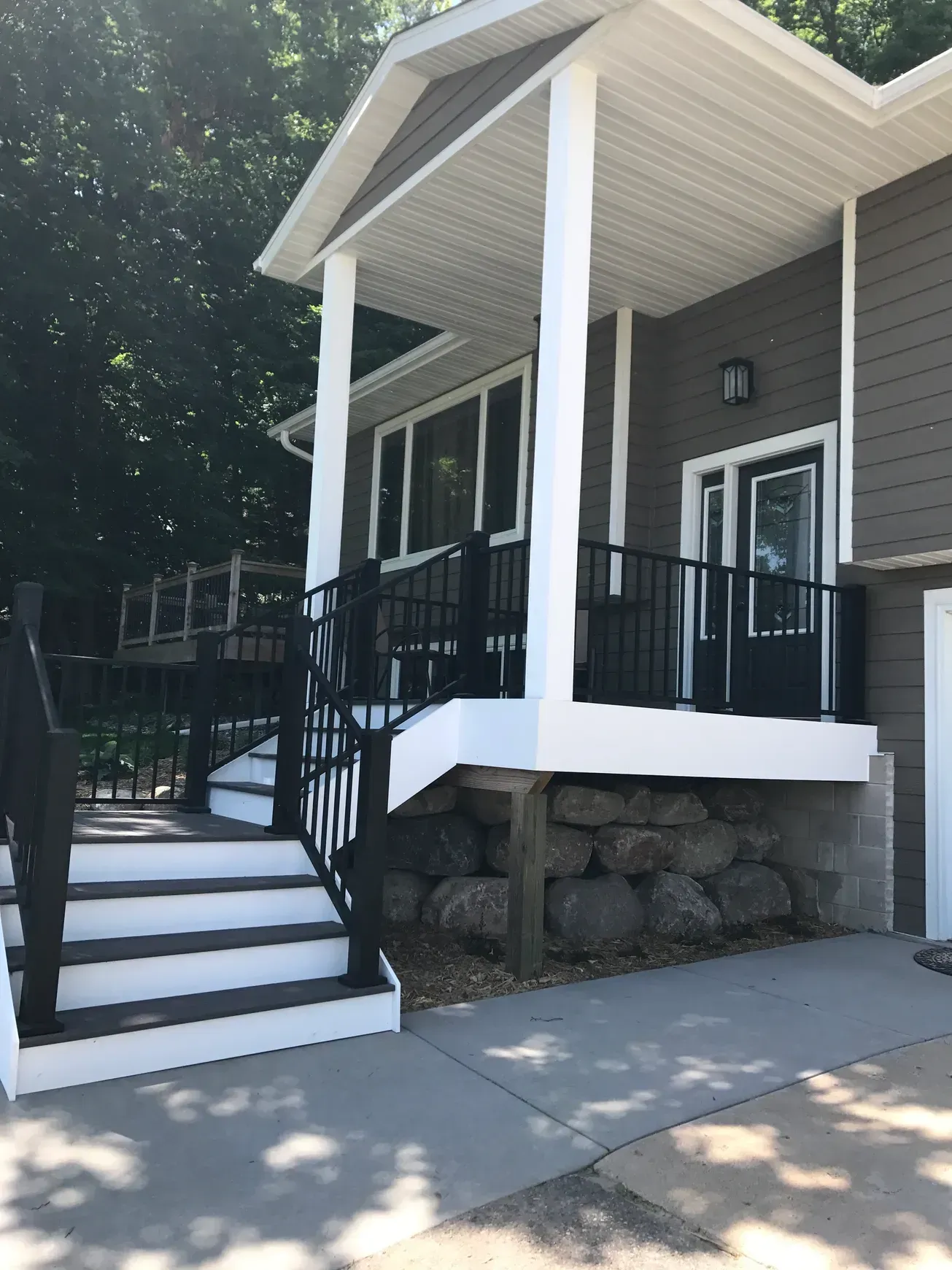 A house with a porch and stairs leading up to it