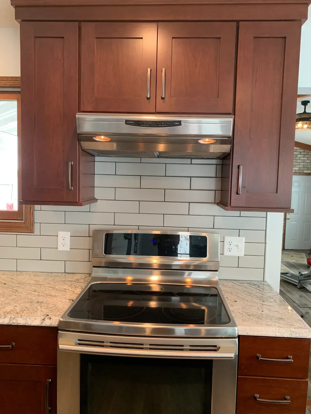 A kitchen with stainless steel appliances and wooden cabinets