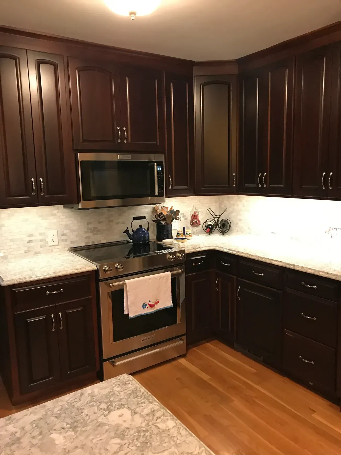 A kitchen with stainless steel appliances and wooden cabinets