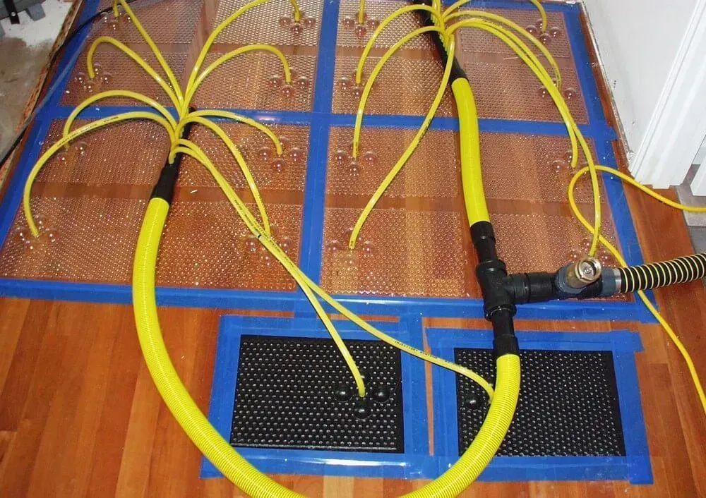 Yellow tubing and mats on floor for water therapy.