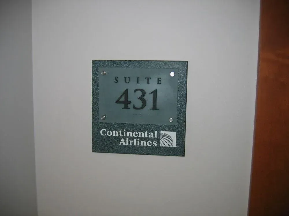 Sign on wall: Suite 431, Continental Airlines logo. Gray square, white text on green.
