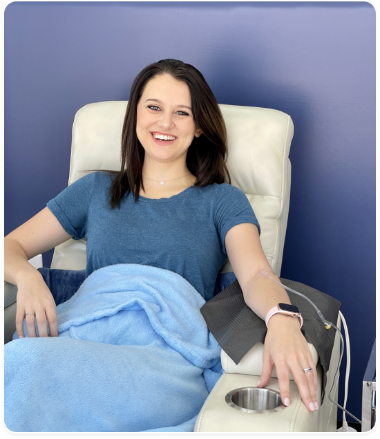 A woman is sitting in a chair with a cup holder