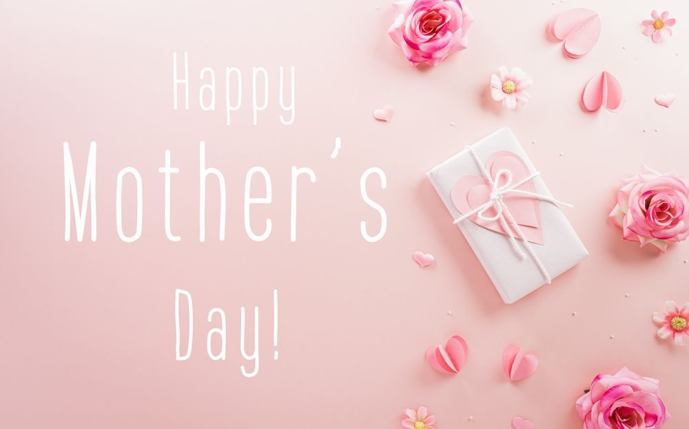 A happy mother 's day greeting card with pink flowers and a gift box on a pink background.