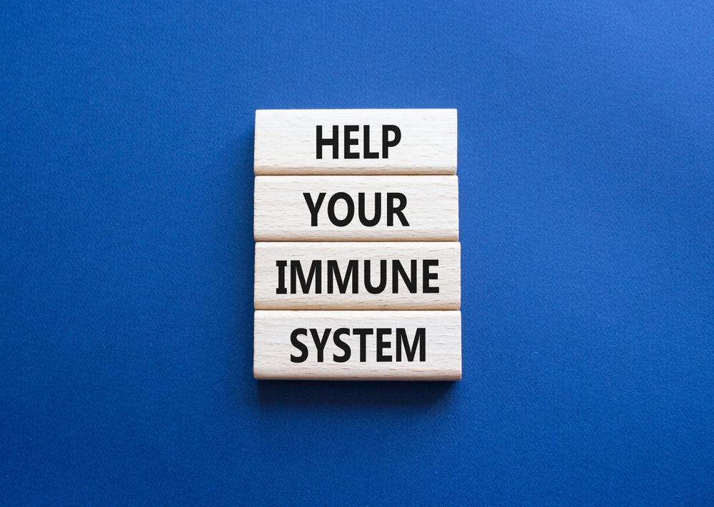 The words `` help your immune system '' are written on wooden blocks on a blue background.