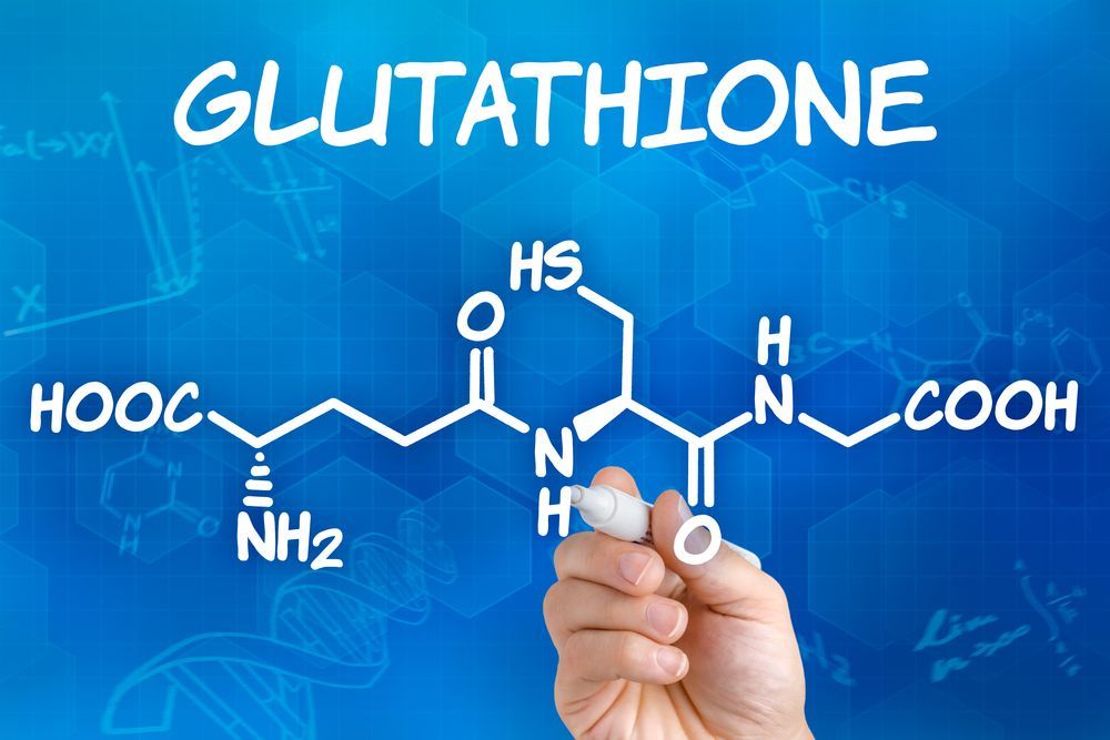 A person is writing the chemical structure of glutathione with a marker.