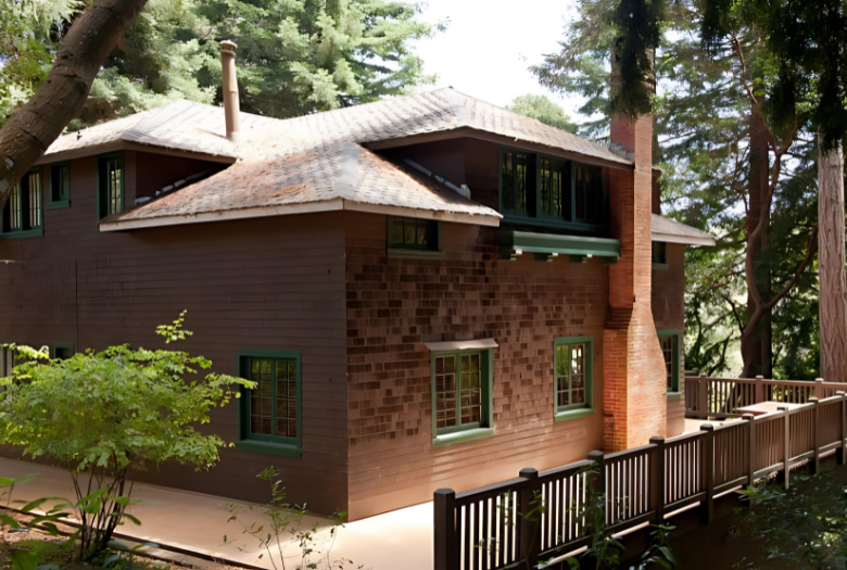 A large brick house with a wooden fence in front of it