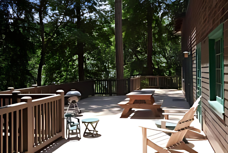 A deck with a picnic table and chairs on it