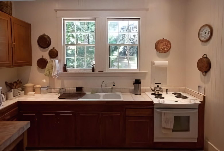 A kitchen with a sink stove and two windows