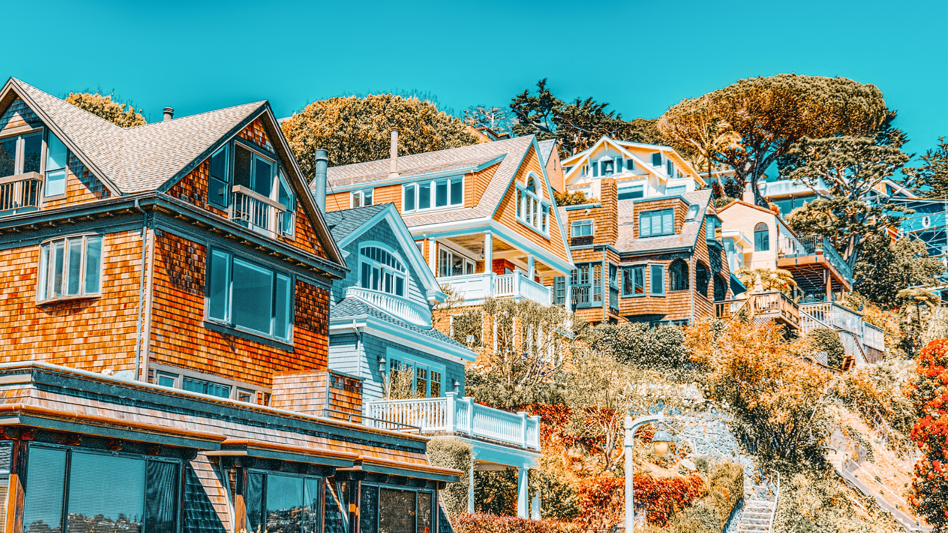 A row of houses sitting on top of a hill.