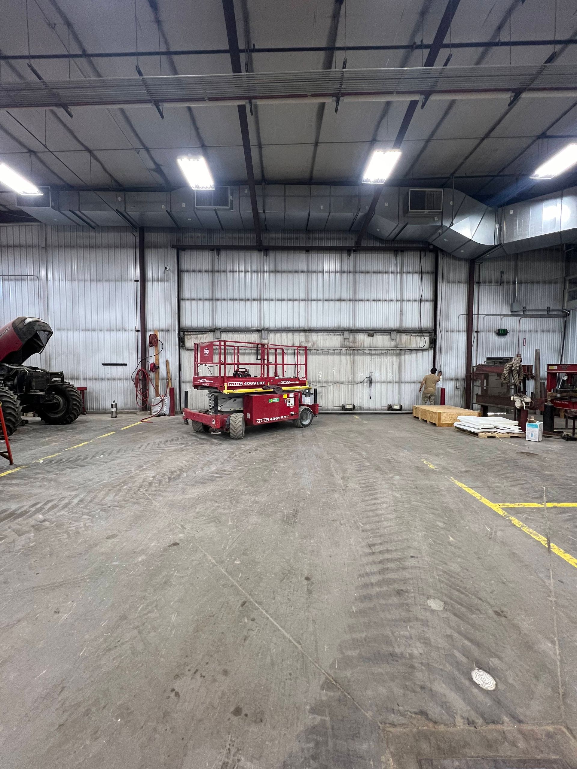 A large warehouse with a lot of machinery inside of it.