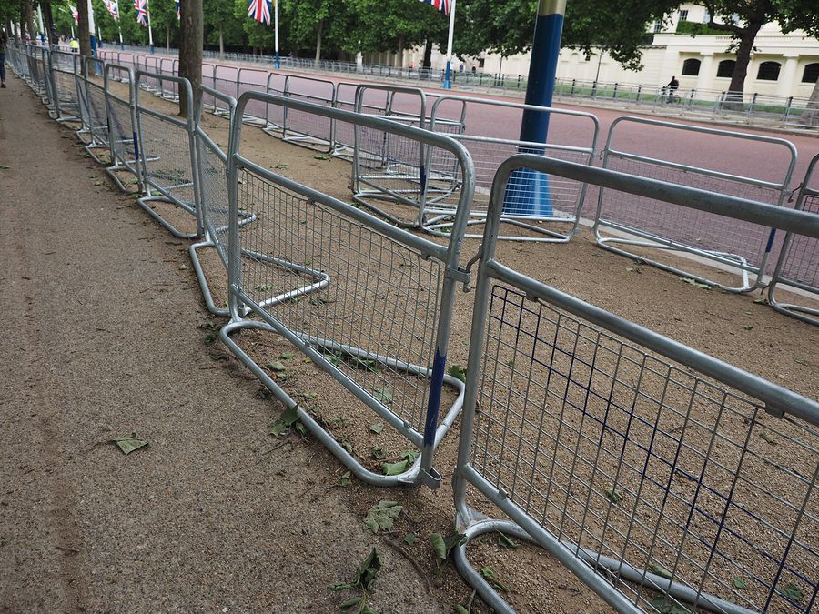 A row of metal fences on the side of a road