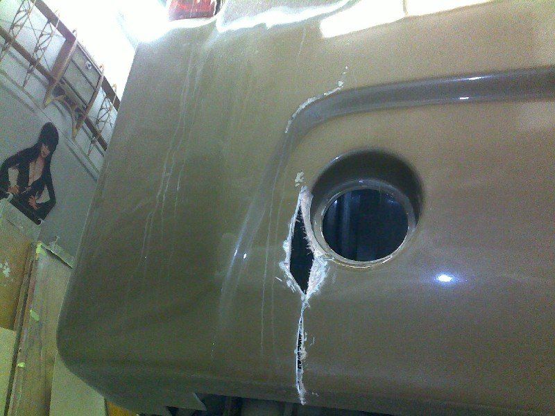 Motorcoach with impact fiberglass damage