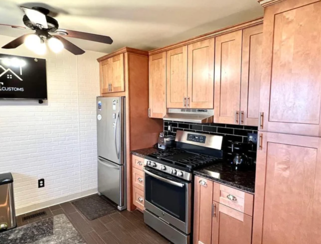 A kitchen with stainless steel appliances and wooden cabinets