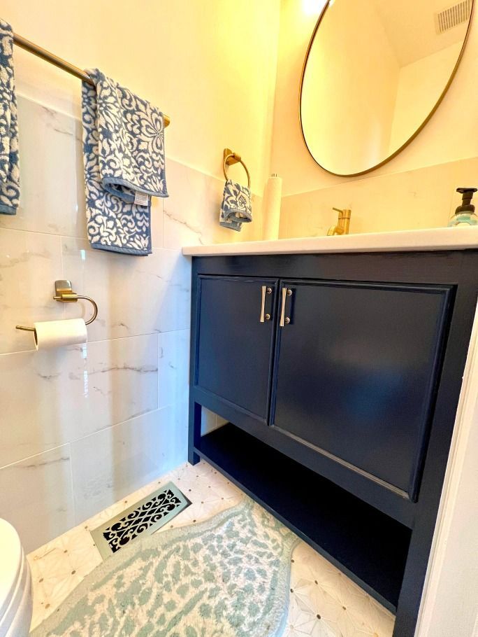 A bathroom with a sink , toilet and mirror.