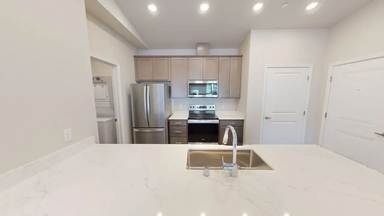 A kitchen with stainless steel appliances and a sink.