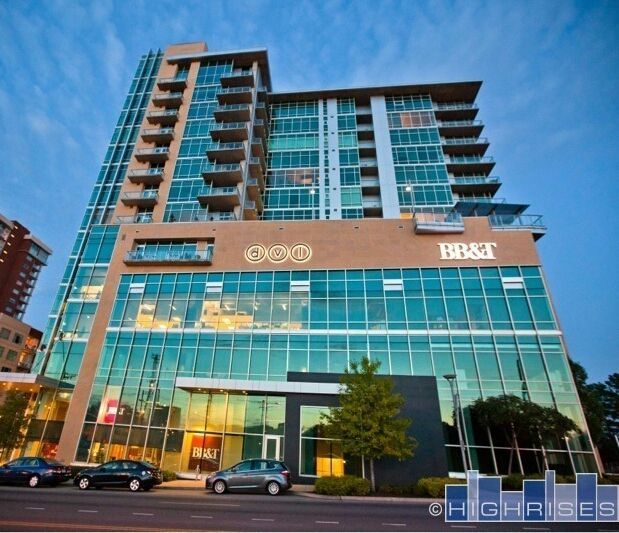 Nashville, Tennessee skyline at dusk with building reflections in the water.