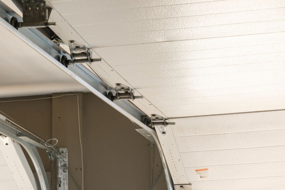 Garage door track and rollers attached to the ceiling.
