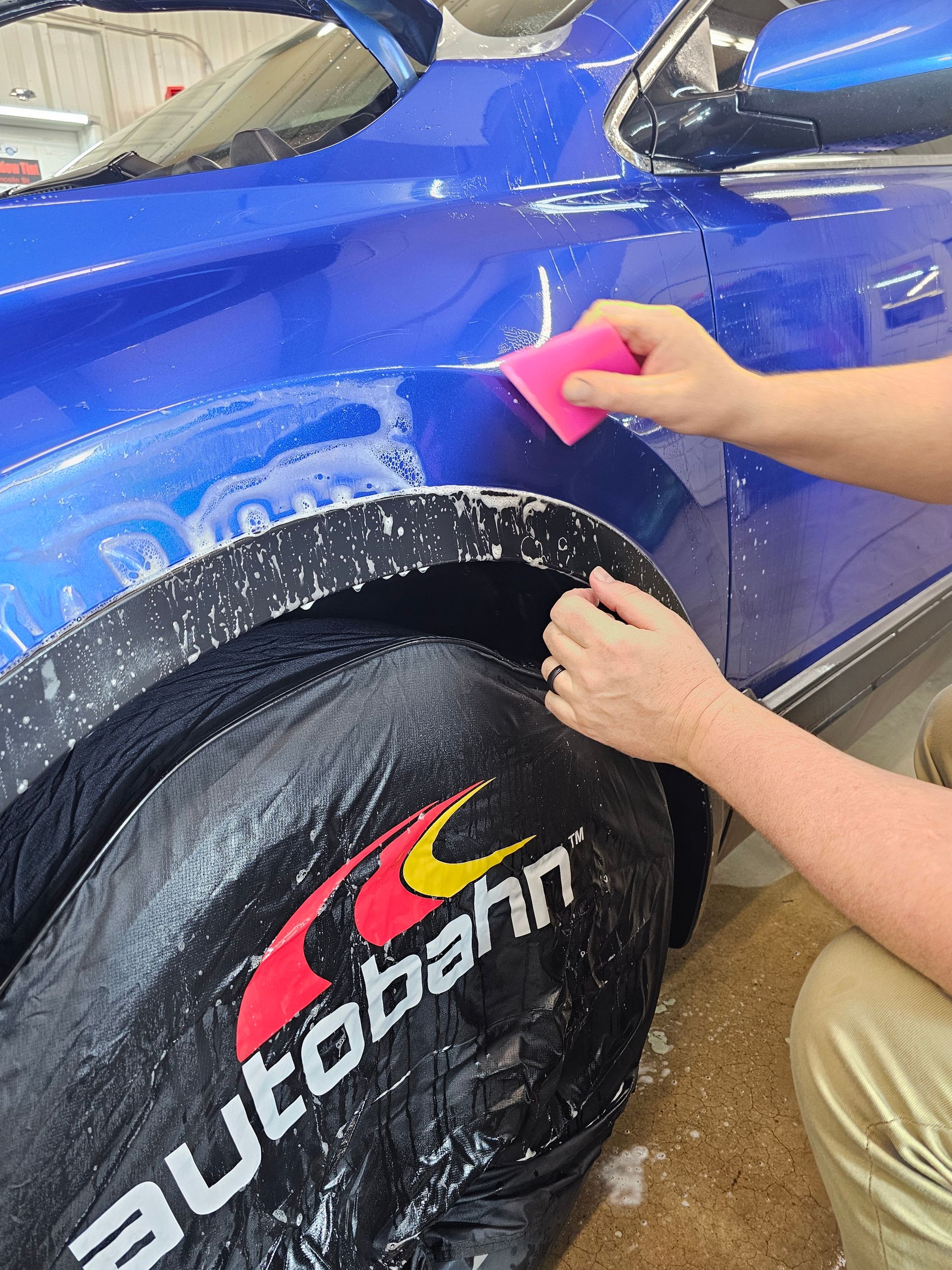 A person is cleaning the seats of a car with a towel.