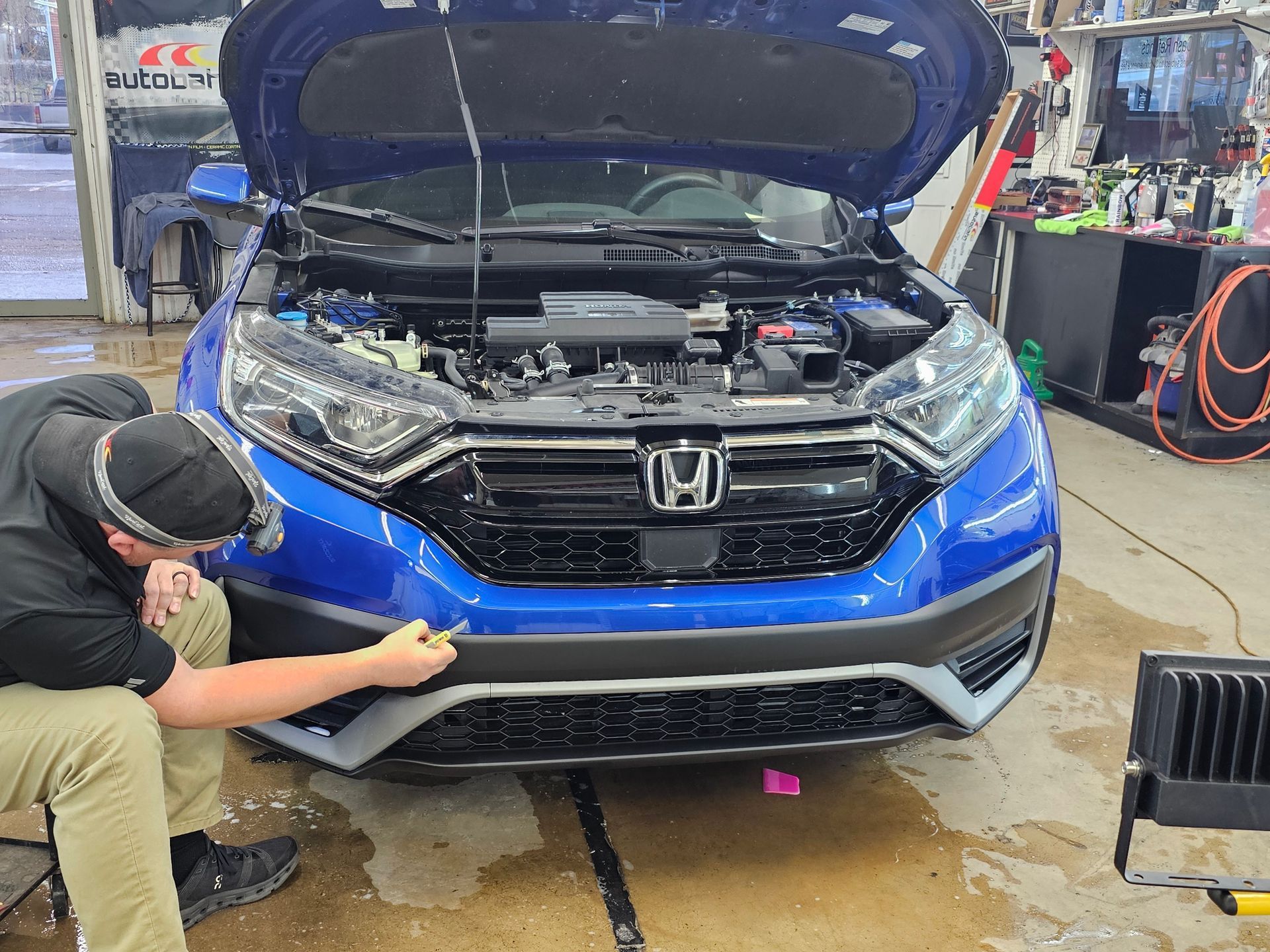 A person is cleaning the seats of a car with a towel.