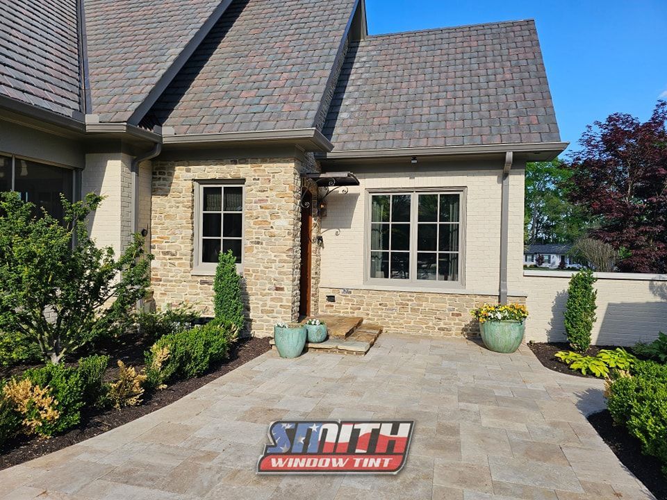 A house with a driveway and a sign that says smith