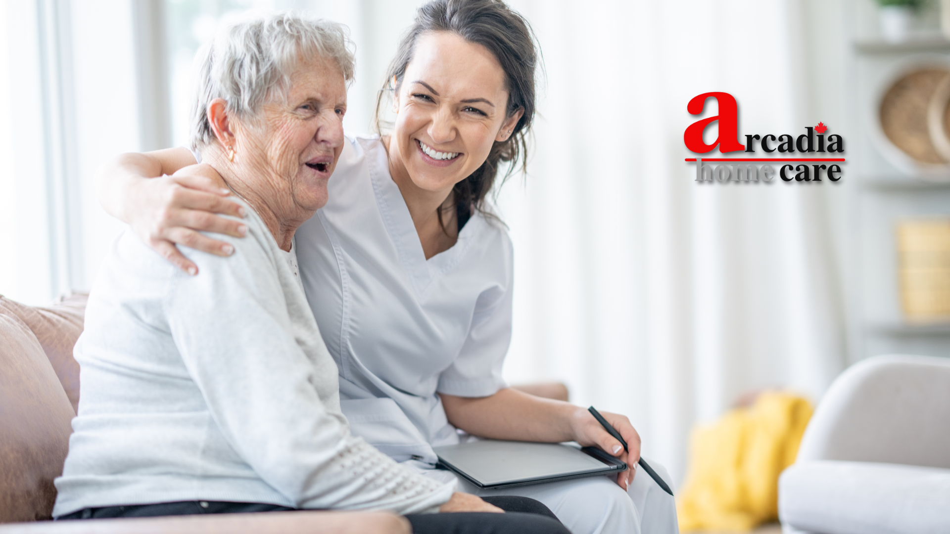 An elderly woman is sitting on a couch with a nurse.