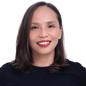 A woman wearing a black shirt and red lipstick is smiling for the camera.