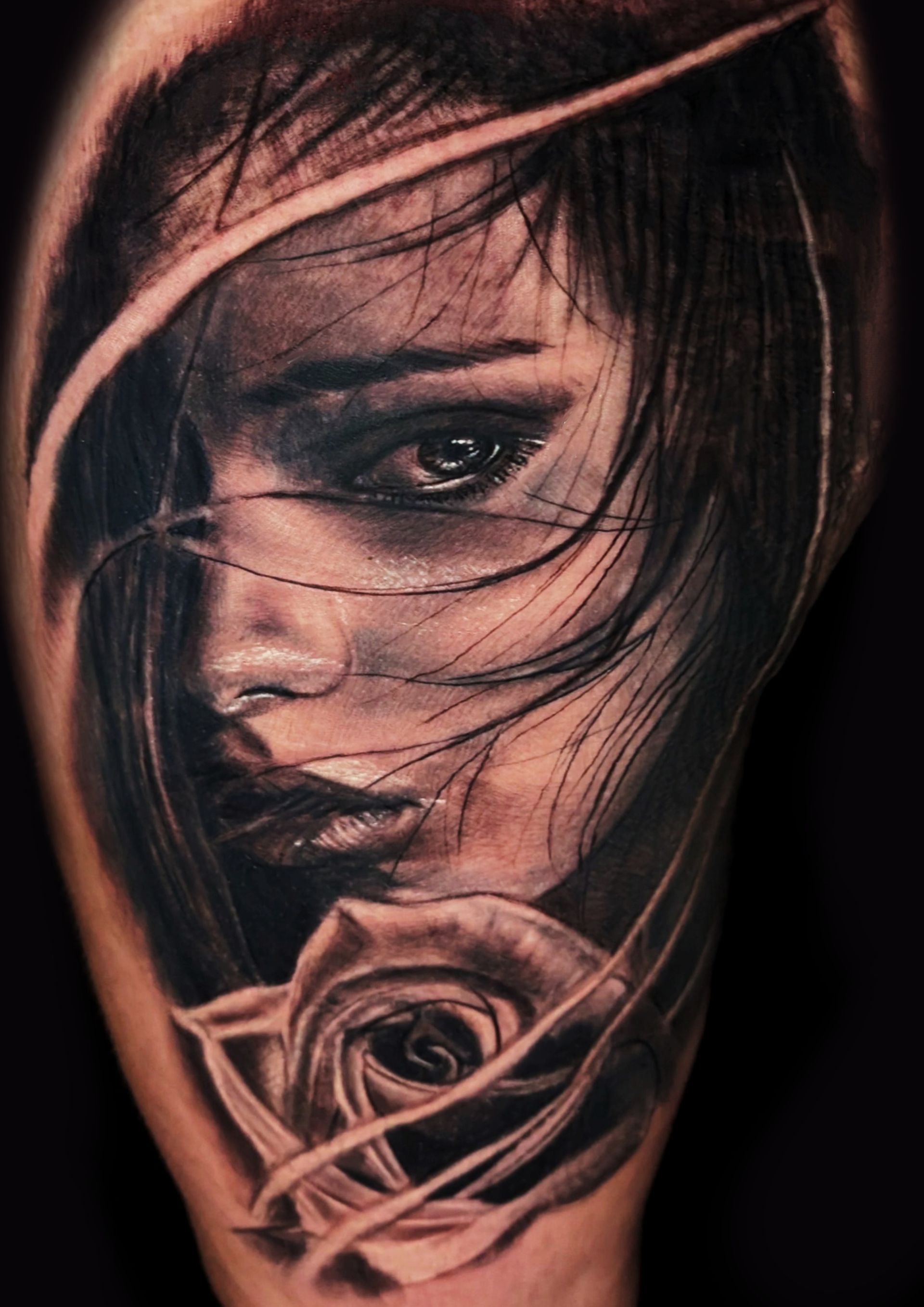 A man is getting a tattoo on another man 's arm.