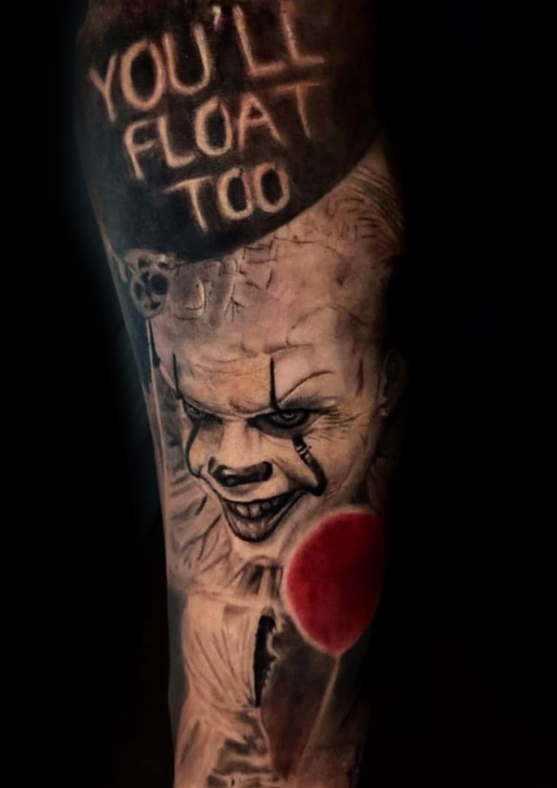 A man is getting a tattoo on another man 's arm.