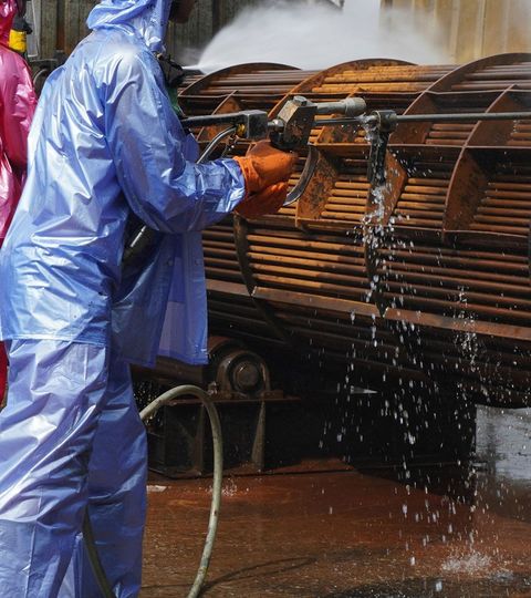 Worker use high pressure water jet to cleaning splashing