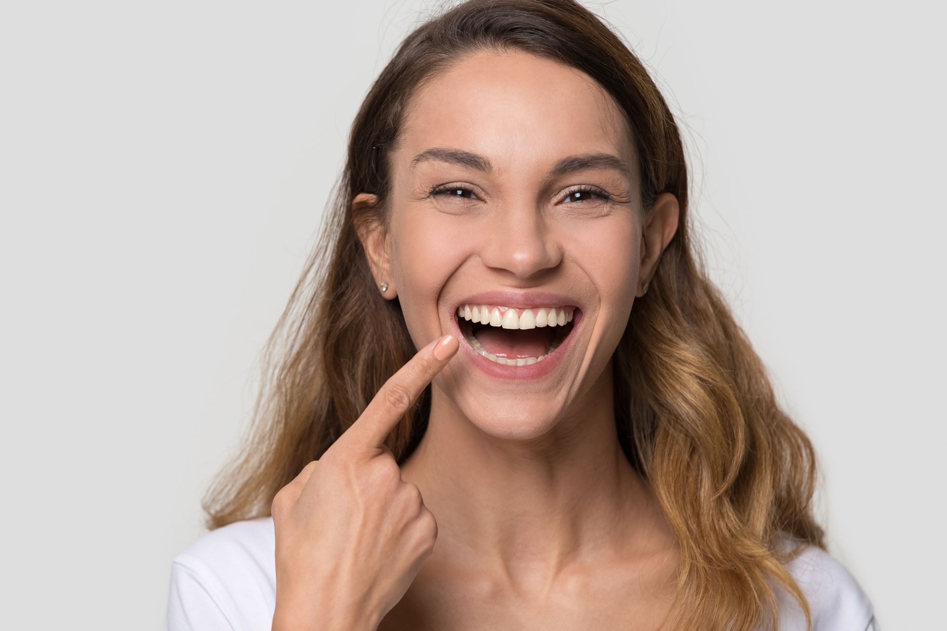 Woman enjoying her smile, highlighting root canal therapy results and overall oral wellness. Woman enjoying her smile, highlighting root canal therapy results and overall oral wellness.