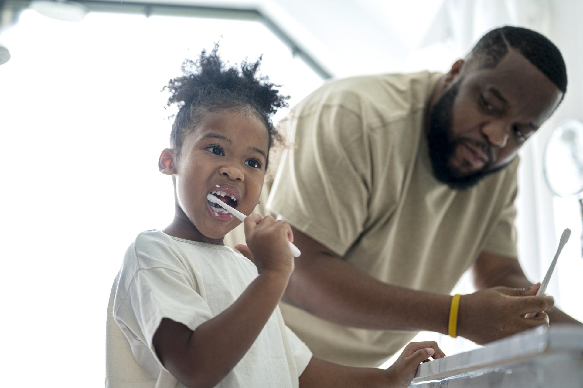 Brushing Her Teeth | Redmond, OR | Highland Family Dental