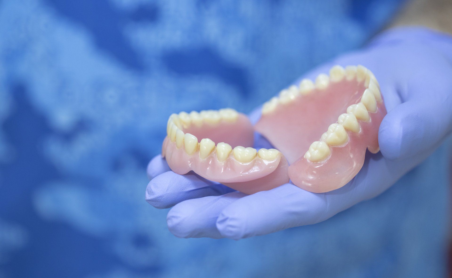Dentist Holding Dentures | Redmond, OR | Highland Family Dental