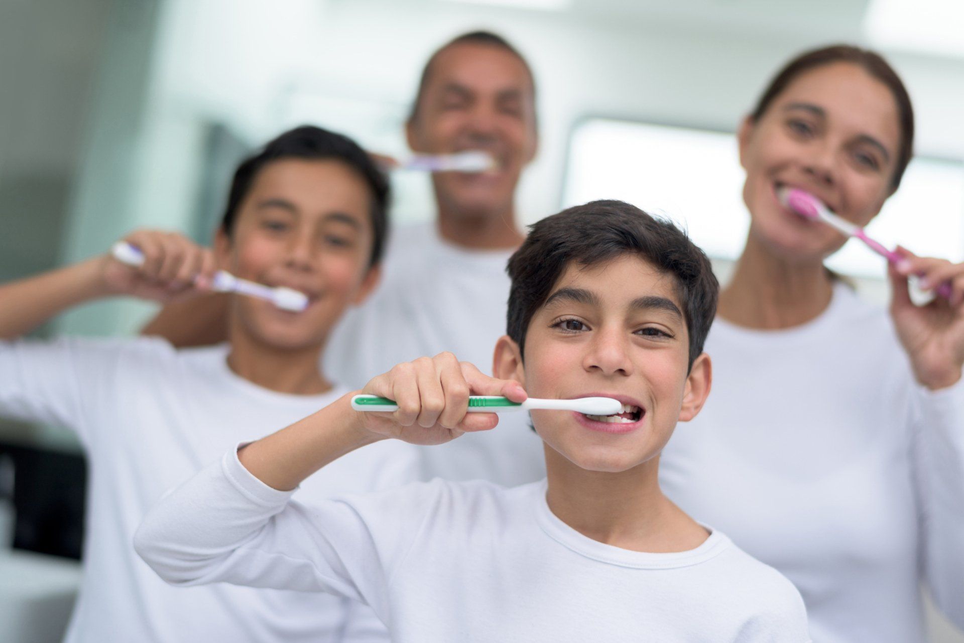 Family Brushing Their Teeth | Redmond, OR | Highland Family Dental