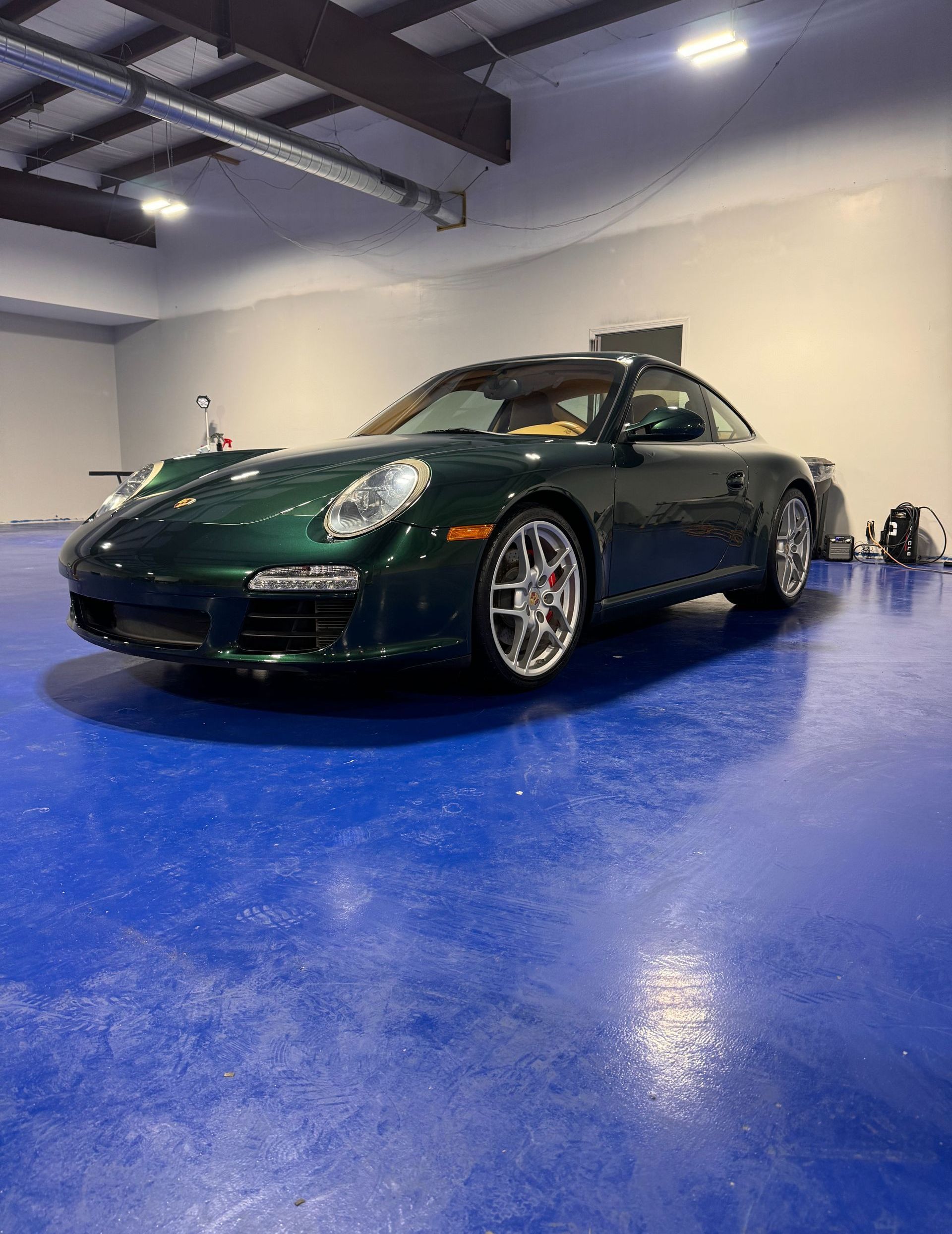 Green Porsche after receiving paint correction and ceramic coating