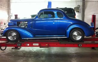 Blue Car On Lift — South Lake Tahoe, CA — Eloise Automotive & Alignment