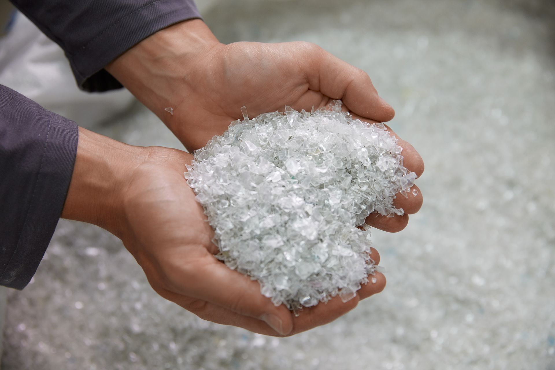 A person is holding a pile of clear plastic in their hands.